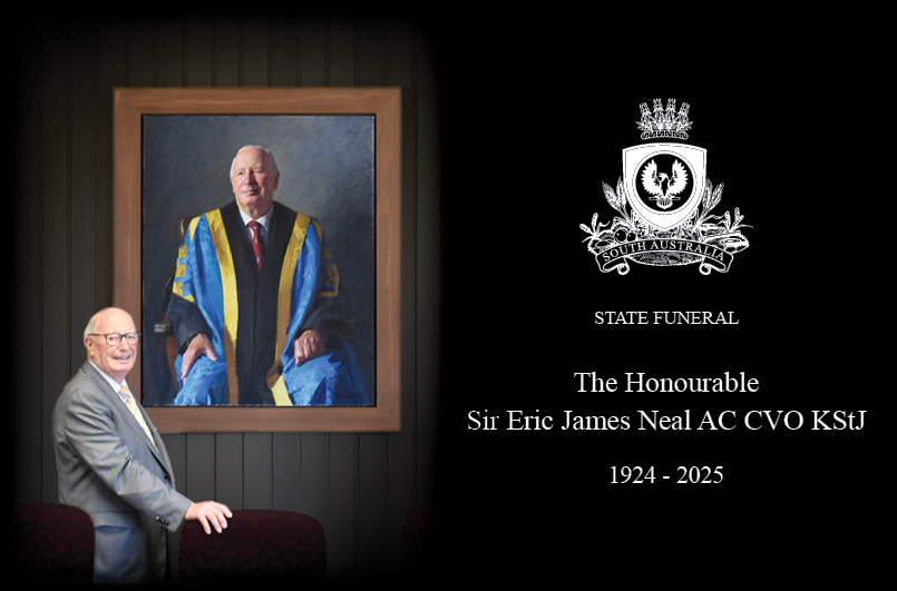 Sir Eric Neal standing in front of his portrait