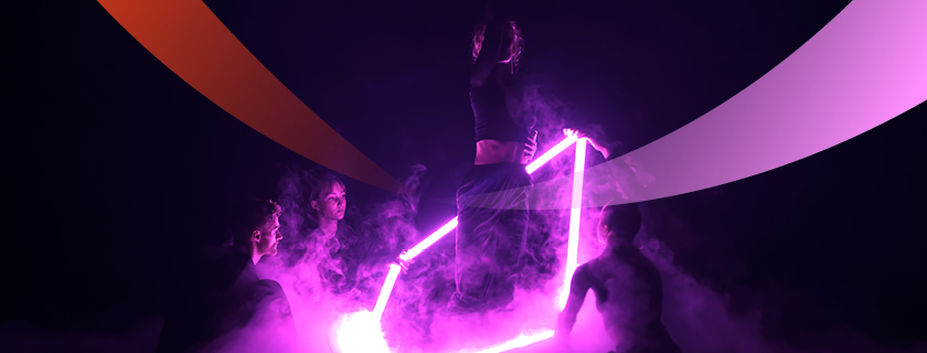 People surrounded by fog, holding a glowing purple light in a dark environment